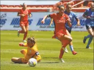  ?? Rick Bowmer / Associated Press ?? The Houston Dash’s Shea Groom beats Chicago Red Stars goalkeeper Alyssa Naeher, left, before scoring during the second half of the NWSL Challenge Cup soccer finals match on Sunday in Sandy, Utah.