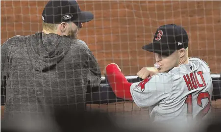  ?? STAFF PHOTO BY CHRISTOPHE­R EVANS ?? FRONT-ROW SEAT: Brock Holt, who hit for the cycle in Game 3, watches from the dugout with Chris Sale during the Red Sox’ series-clinching win last night at Yankee Stadium. Sale pitched the eighth inning.