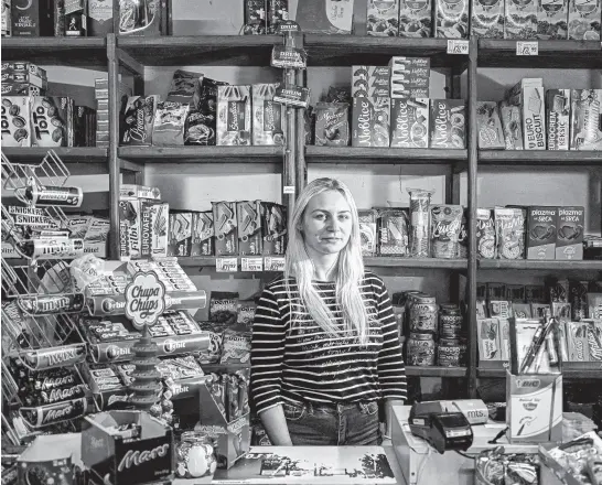  ?? REUTERS ?? Marija Jankucic, 20, a student, poses for a picture inside the grocery shop where she works in the village of Krivelj, Serbia, on April 3. “I am hoping for a new village in a peaceful area,” said Jankucic during an interview with Reuters.