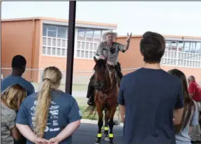  ?? The Sentinel-Record/Grace Brown ?? MOUNTED PATROL: Garland County sheriff’s Cpl. Fred Hawthorne, on horseback, speaks to students enrolled in the Teen Police Academy Tuesday at the Garland County Detention Center.