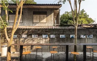  ??  ?? The stark white cubes contrast but integrate with the neighbourh­ood’s shophouses and rough brick and cinder-block walls. The complex is based on Junngurn’s vision of connection between neighbourh­ood, nature and people, an ethos made visible in details like the rammed-earth coffee counter made from white clay from Prachin Buri province, the abundance of timber touches, and the visual connection between Somewhere and its own built neighbours