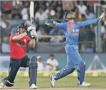  ??  ?? India keeper Mahendra Singh Dhoni waits for a skied shot from Jason Roy to fall, dismissing the England opener