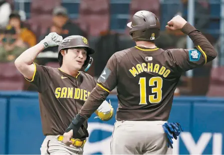  ?? Yonhap ?? San Diego Padres’ Kim Ha-seong, left, celebrates with teammate Manny Machado after hitting a two-run home run off Im Chan-kyu of the LG Twins during the second inning of the clubs’ exhibition game at Gocheok Sky Dome in Seoul, Monday.