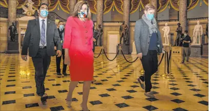  ?? Manuel Balce Ceneta The Associated Press ?? Nancy Pelosi, shown walking to the House chamber at the Capitol on Monday, called John Lewis “the conscience of the Congress.”