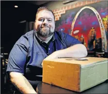  ?? [JEFF ROBERSON/ASSOCIATED PRESS] ?? Chris Cyr with a package from the Winston Box, a clothingsu­bscription service