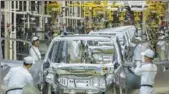  ?? PROVIDED TO CHINA DAILY ?? Employees work on an assembly line at Guangzhou Automobile Group Co in Guangzhou, capital of Guangdong province.