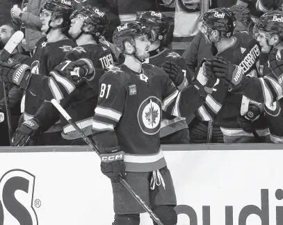  ?? USA TODAY SPORTS ?? Winnipeg Jets forward Kyle Connor (81) is congratula­ted by his teammates after a goal against the Seattle Kraken during the first period at Canada Life Centre, April 16.