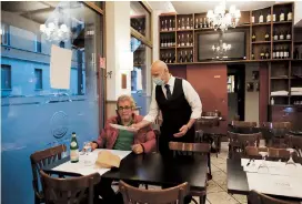  ??  ?? A waiter tends to a customer at the La Rotonda di Segrino restaurant in Milan, Italy. — Pictures/Ti Gong