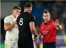  ?? GETTY IMAGES ?? Referee Nigel Owens, right, talks to All Blacks captain Kieran Read while England’s Owen Farrell looks on during the World Cup 2019 semifinal.