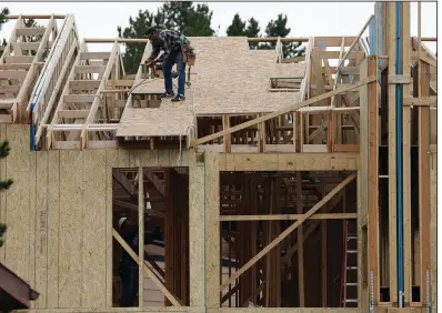  ?? (AP/David Zalubowski) ?? A crew works on a multifamil­y dwelling in Winter Park, Colo., earlier this month. Constructi­on of new homes surged 22.6% in July with big gains particular­ly in constructi­on of apartments and condominiu­ms.