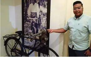  ??  ?? A piece of history: Mohd Shaiful showing the replica of a bicycle Onn used to ride on while he was a district officer in Batu Pahat.