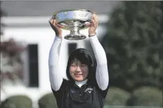  ?? DAVID J. PHILLIP ?? TSUBASA KAJITANI, OF JAPAN, holds up the trophy after winning the Augusta National Women’s Amateur golf tournament at Augusta National Golf Club Saturday in Augusta, Ga.