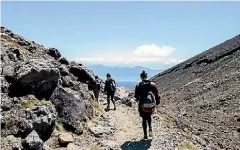  ??  ?? Walking the Tongariro Crossing.