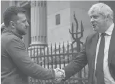  ?? UKRAINIAN PRESIDENTI­AL PRESS OFFICE ?? Ukrainian President Volodymyr Zelenskyy, left, and Britain’s Prime Minister Boris Johnson shake hands Saturday in Kyiv, Ukraine.