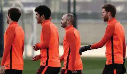  ??  ?? Iniesta with other Barcelona players during yesterday’s training session