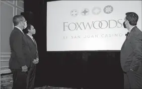  ?? COURTESY OF FOXWOODS ?? From left, Puerto Rico Gov. Pedro Pierluisi, Mashantuck­et Chairman Rodney Butler and Andro Nodarse-León, founder and chief executive officer of LionGrove, the hospitalit­y investment firm that owns the Fairmont El San Juan Hotel on Tuesday, reveal the new logo for Foxwoods El San Juan Casino.
