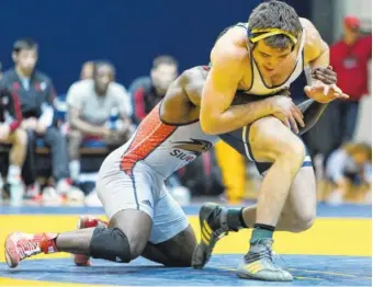  ?? STAFF PHOTO BY ERIN O. SMITH ?? UTC’s’s Ben Stacey breaks away from SIU-Edwardsvil­le’s Tommy Helton during the 285-pound match at Maclellan Gym on Friday. Stacey won 13-7.