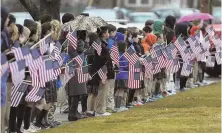  ?? STAFF PHOTOS BY CHRISTOPHE­R EVANS ?? A HERO’S FAREWELL: An Army honor guard, center and left, accompanie­d Hauterman from funeral home to church to St. Jerome Cemetery. Blessed Sacrament students, above, were among hundreds along the route.