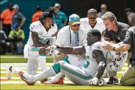  ?? ALLEN EYESTONE / THE PALM BEACH POST ?? Dolphins defensive end William Hayes (95) is helped up after getting injured on a sack of Oakland Raiders quarterbac­k Derek Carr on Sunday in Miami Gardens. Hayes also missed the last six games in 2017 because of injury.