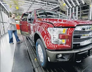  ?? Charlie Riedel Associated Press ?? FORD’S SALES in December rose 1.3% on the strength of its trucks, especially the enormously popular FSeries pickup. Above, a worker inspects a new Ford F-150 truck at an assembly plant in Missouri in 2015.