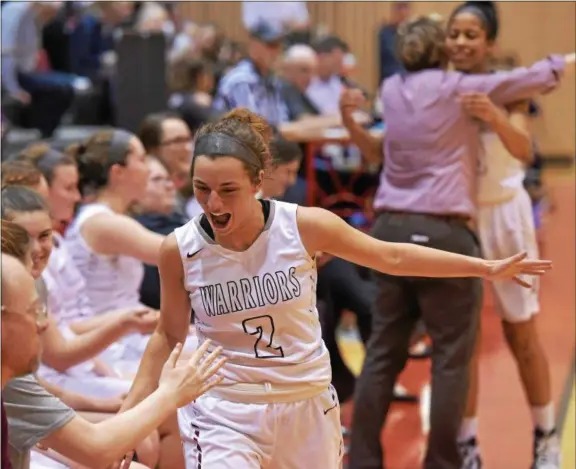  ?? PETE BANNAN — DIGITAL FIRST MEDIA ?? West Chester Henderson senior Maddie DePrisco is congratual­ted by teammates as the Warriors cruised to victory over Mount St. Joseph Academy in District 1 semifinal action at Harriton Tuesday.