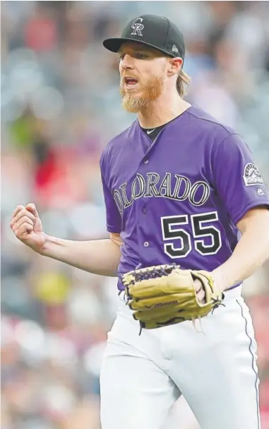  ?? Matthew Stockman, Getty Images ?? Rockies pitcher Jon Gray celebrates after striking out Philadelph­ia Phillies second baseman Cesar Hernandez during the fifth inning Sunday at Coors Field.