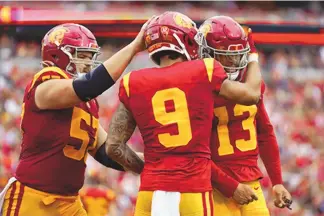  ?? ASHLEY LANDIS/ASSOCIATED PRESS ?? Southern California wide receiver Michael Jackson III (9) celebrates with teammates Justin Dedich (57) and Caleb Williams (13) after scoring a touchdown during the Trojans’ victory over Nevada on Saturday.