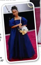  ??  ?? Quvenzhane Wallis, with a silver headband in her hair and carrying her puppy purse, wore an armani Junior navy-blue dress.