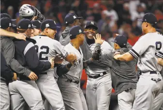  ?? Gregory Shamus / Getty Images ?? Aroldis Chapman (facing) and the Yankees exult after eliminatin­g Cleveland from the postseason. Chapman pitched two hitless innings to pick up his second save in the ALDS.