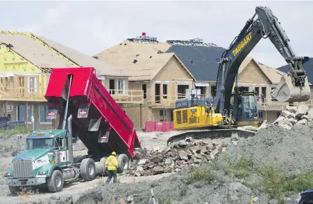  ?? SEAN KILPATRICK, CP ?? New homes under constructi­on in Ottawa last August. The Canada Mortgage and Housing Corporatio­n says constructi­on of new homes in Canada’s six largest cities remained stable at near all-time high levels last year, driven by a surge of new apartment starts.