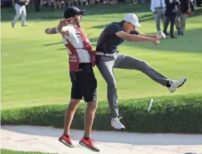  ?? BILL STREICHER/USA TODAY SPORTS ?? Jordan Spieth and caddie Michael Greller react after the golfer chipped out of a bunker for a hole-out birdie in last year’s Travelers.