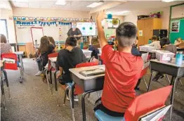  ?? JARROD VALLIERE U-T ?? Rya Hege teaches her fourth-grade class at The Leadership Academy in Vista on Wednesday. Protocols for exit, entry, meals and movement are in place.