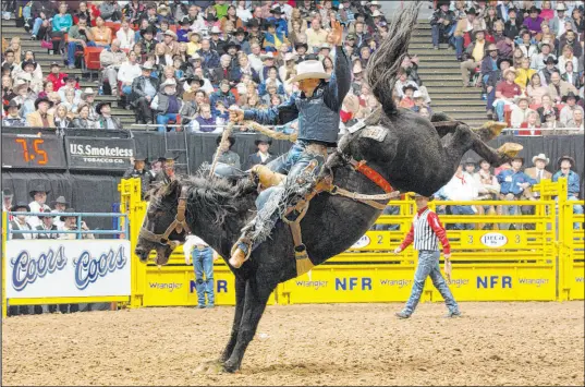  ?? PRCA ?? Saddle bronc superstar Billy Etbauer, shown on one of his many rides at the Wrangler National Finals Rodeo, will be honored tonight as a member of the Vegas NFR Icons Class of 2023.