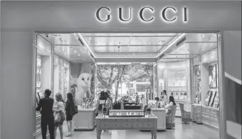 ?? PROVIDED TO CHINA DAILY ?? Consumers shop at a Gucci beauty store in a department store in downtown Shanghai on June 11.