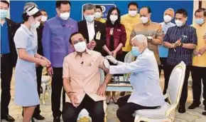  ?? EPA PIC ?? A handout photo by the Royal Thai Government showing Prime Minister Prayuth Chan o Cha receiving a shot of vaccine developed by AstraZenec­a before the cabinet meeting in Bangkok yesterday.