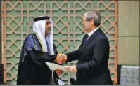  ?? SANA VIA REUTERS ?? Syrian Foreign Minister Faisal Mekdad (right) receives the credential­s of the new ambassador of the United Arab Emirates to Syria, Hassan Ahmad al-Shihi, in Damascus on Tuesday.