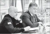  ?? Mykola Lazarenko Pool Photo ?? UKRAINIAN President Petro Poroshenko, right, said that Russia concocted the terrorism accusation­s.