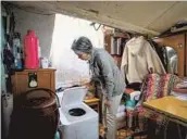  ?? — Jiang Xiaowei ?? Wei Hui inspects the newly installed biodegrada­tion toilet, which requires no water or pipes, in her loftstyle home.