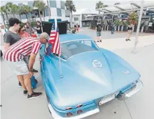  ?? John Raoux, The Associated Press ?? Guests look at a Corvette once owned by Apollo 11 astronaut Neil Armstrong at the Kennedy Space Center Visitor Complex on Saturday in Cape Canaveral, Fla.