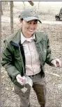  ?? (Courtesy Photo) ?? Susan Adkins, superinten­dent of Prairie Grove Battlefiel­d State Park, displays an artifact found during a recent archeologi­cal survey at the park on the hillside near the Borden House.