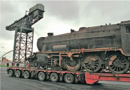  ??  ?? Left: When the Scottish Railway Preservati­on Society unveiled its repatriate­d North British-built exTurkish State Railways Stanier 8F No. 45170 on November 13, 2014, it chose the crane as the venue, making the 2-8-0 the first locomotive to have been at the giant's foot for 52 years. The 1942-built locomotive is to be restored to working order for use on the Bo'ness & Kinneil Railway after an exile of over 70 years.
HUGH DOUGHERTY
Below: An Indian State Railways YP class Pacific, one of 100 built by the North British Locomotive Company, is lifted by the Finnieston Crane on to a ship in 1952. GLASGOW MITCHELL LIBRARY/BIG CRAN COMPANY