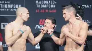  ?? ADRIAN WYLD/THE CANADIAN PRESS ?? Rory MacDonald and Stephen Thompson pose for the camera Friday at the weigh-in for UFC Fight Night in Ottawa. Montreal-based MacDonald was the favourite of fans at the event.