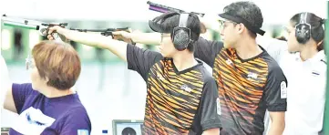  ?? — Bernama photo ?? National shooting pair, Johnathan Wong Guanjie (second right) and Joseline Cheah Lee Yean (second left) compete in the mixed 10m air pistol event.