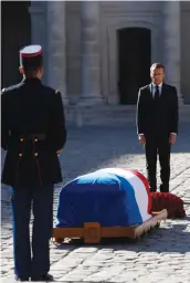  ?? — AP ?? French President Emmanuel Macron stands by the coffin of Charles Aznavour during a ceremony to pay tribute to late singer Aznavour in Paris, on Friday .