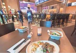  ?? MARK HOFFMAN / MILWAUKEE JOURNAL SENTINEL ?? Sample menu items are displayed Wednesday at Movie Tavern by Marcus at Brookfield Square, which opens Friday.