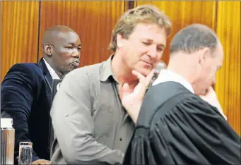  ?? Picture: EUGENE COETZEE ?? NEXT MOVE: Investigat­ing officer Kanna Swanepoel, centre, in discussion with state advocate Marius Stander during a break in court proceeding­s. State witness Luthando Siyoni is behind them