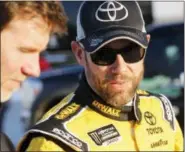  ?? STEVE HELBER — THE ASSOCIATED PRESS ?? Matt Kenseth, right, talks to a crew member after winning the pole for the Monster Energy Cup Series auto race at Richmond Internatio­nal Raceway in Richmond, Va., Friday.