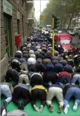  ?? ASSOCIATED PRESS FILE PHOTO ?? Muslims face Mecca during their traditiona­l Friday prayer in Milan, Italy.