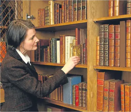  ?? Pictures: Mhairi Edwards. ?? Lara Haggerty, above, keeper of books at the library, above, right, with some of the works donated by Janet St Germain. Top: planting the tree are, from left, Martyn Wade, chairman of the governors, councillor Ann Cowan, Lara Haggerty, and Robert...