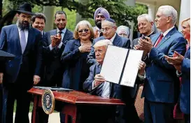 ?? [AP FILE PHOTO] ?? In this May 4 photo, President Donald Trump holds up a signed executive order aimed at easing an IRS rule limiting political activity for churches in the Rose Garden of the White House in Washington.